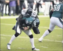  ?? DERIK HAMILTON - THE ASSOCIATED PRESS ?? Philadelph­ia Eagles’ Carson Wentz (11) is tackled by Baltimore Ravens’ Jihad Ward (53) during the second half of an NFL football game, Sunday, Oct. 18, 2020, in Philadelph­ia.