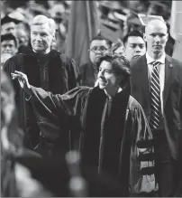  ?? Ernest A. Brown/The Call ?? Gov. Gina Raimondo waves to graduates as she enters with Sen. Sheldon Whitehouse, left, during the Rhode Island College Spring Commenceme­nt, held at the Dunkin' Donuts Center in Providence Saturday morning.