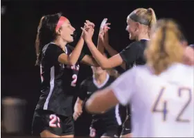  ?? AUSTIN HERTZOG - MEDIANEWS GROUP ?? Boyertown’s Samantha Goffice, left, and Camilla Kuever high-five after Goffice’s second goal against Upper Perkiomen in Tuesday’s PAC semifinal.