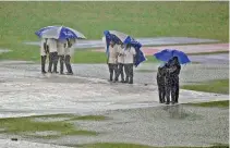  ?? ?? Rain made life extremely difficult for the travelling fans