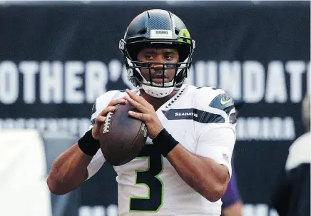  ?? DAVID BANKS / THE ASSOCIATED PRESS ?? Seattle QB Russell Wilson warms up on Monday. There have been hopes the Seahawks might remain in playoff contention by building around Wilson on offence and linebacker Bobby Wagner on defence.