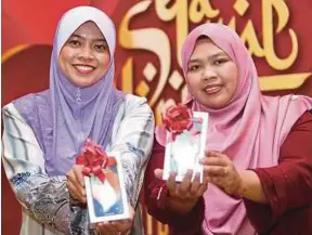  ??  ?? Kamilia Hani (kiri) dan Nas Liana Ahmad Nasi menunjukka­n hadiah yang dimenangi di Kuala Lumpur, semalam.