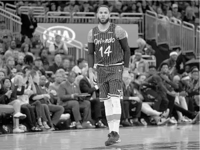  ?? PHELAN M. EBENHACK/AP ?? Guard D.J. Augustin reacts after making a shot during the second half against the visiting Hawks on April 5 in Orlando. His high school in New Orleans retired his jersey Saturday.