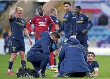  ?? ?? Joe Shaughness­y gets treatment for his ‘significan­t knee injury’ during the recent Rangers clash.