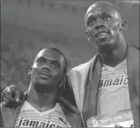  ?? ASSOCIATED PRESS FILE PHOTO ?? Nesta Carter, left, and Usain Bolt celebrate after the men’s 4x100-metre relay final at the Beijing 2008 Olympics.