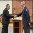  ??  ?? Greg Mitskvich, who has been with the Eastlake Fire Department for 14 and a half years, being sworn in by Mayor and Safety Director Dennis Morley, Eastlake, as a fire lieutenant.