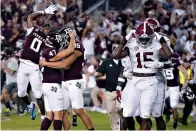  ?? The Associated Press ?? ■ Texas A&M’s Seth Small (47) celebrates with Nik Constantin­ou (95) and Ainias Smith (0) after his game-winning field goal, as Alabama linebacker­s Dallas Turner (15) and Will Anderson Jr. leave the field Saturday in College Station, Texas.