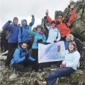  ??  ?? Members of Rodger Duckworth Physiother­apy at the top of Mount Snowdon