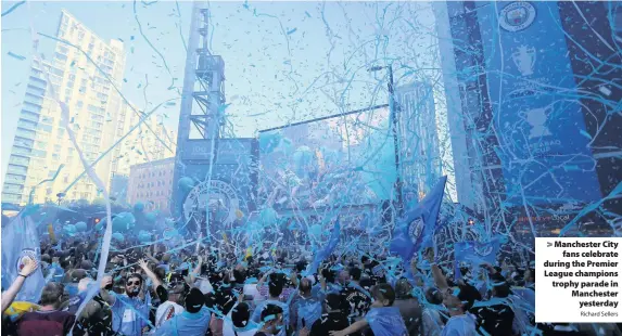  ?? Richard Sellers ?? > Manchester City fans celebrate during the Premier League champions trophy parade in Manchester yesterday