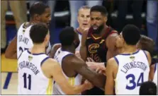  ?? BEN MARGOT — THE ASSOCIATED PRESS ?? Cavaliers center Tristan Thompson, facing, confronts Warriors forward Draymond Green, second from bottom left, during overtime of Game 1 of NBA Finals in Oakland last week.