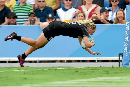  ?? GETTY IMAGES ?? Kelly Brazier dives across to score her superb matchwinni­ng try in extra time to seal a gold medal for the New Zealand women’s team.