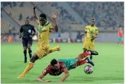  ??  ?? Sent off…Mali’s Issa Samake (L) was shown a second yellow card late on in the final