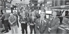  ?? RICHARD DREW, AP ?? Traders on the floor of the New York Stock Exchange pause for a moment of silence on the 16th anniversar­y of the 9/11 attacks.