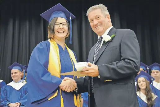  ?? LAWRENCE POWELL ?? Valedictor­ian Mary Baker receives the Queen Elizabeth II Medal from Bridgetown Regional High School principal Bill Reid during the final graduation ceremony at the school. Next year students will graduate from the new Bridgetown Regional Community...