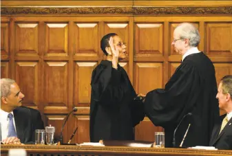  ?? Skip Dickstein / Albany (N.Y.) Times Union 2013 ?? Judge Sheila Abdus-Salaam in 2013 is sworn in as the first female African American judge of New York’s top court, a ceremony attended by then-U.S. Attorney General Eric Holder (left).