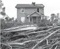  ??  ?? Cleaning efforts begin in a neighborho­od damaged by a storm system that passed through the Dayton, Ohio, area on Monday.