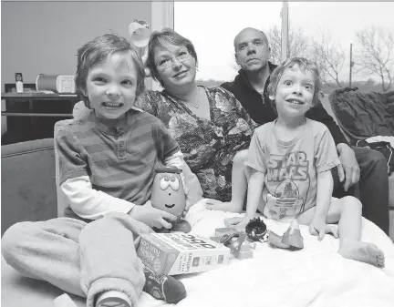  ?? JEAN LEVAC/OTTAWA CITIZEN ?? Lucas MacArthur, right, has been diagnosed as having autism but can’t get the intensive behaviour interventi­on treatment he needs because of the waiting list and cost. He is shown here with his brother Jesse MacArthur, mom Tanya Corey and dad John...
