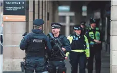  ?? ADRIAN DENNIS, AFP/GETTY IMAGES ?? Armed police secure the area across the road from the Palace of Westminste­r in central London on Thursday.