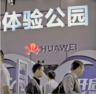  ?? AP PHOTO ?? HOMEGROWN TECHNOLOGY: Visitors look at a display for 5G wireless products from Chinese tech firm Huawei at the PT Expo in Beijing, Wednesday.