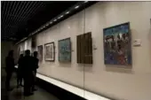  ?? LIU XIANGRUI / CHINA DAILY ?? Visitors view artworks on show at the ongoing Sino-African art-exchange exhibition at the National Library in Beijing.