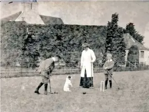  ?? (John Thomson/SWNS) ?? The family has fun with the pet Jack Russell on the croquet lawn