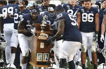  ?? BARRY REEGER - THE ASSOCIATED PRESS ?? Rasheed Walker (53) celebrates with Penn State teammate Shane Simmons (34) after the Nitany Lions defeated Michigan State to win the Land-Grant Trophy last Saturday.