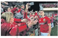  ??  ?? Smile, please: Owen Farrell poses with Lions supporters