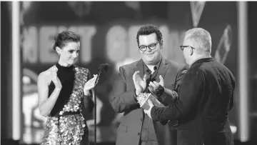  ??  ?? Actors Emma Watson and Josh Gad and director Bill Condon accept the Movie of the Year award for ‘Beauty and the Beast’ onstage during the 2017 MTV Movie And TV Awards at The Shrine Auditorium on Sunday in Los Angeles, California. — AFP photo