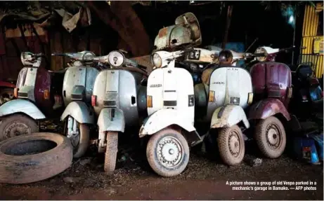  ??  ?? A picture shows a group of old Vespa parked in a
mechanic’s garage in Bamako. — AFP photos