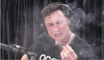  ??  ?? Elon Musk smokes marijuana during a streamed YouTube video with comedian Joe Rogan