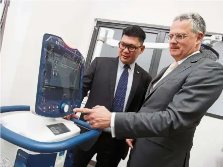  ??  ?? Woo (left) and Dr Schabacker having a look at one of the ventilator­s to be tested at ECRI’s new medical device evaluation laboratory in Bandar Sunway – the only one outside the US. — FAIHAN GHANI/The Star