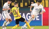  ??  ?? Real Madrid's Cristiano Ronaldo fights for the ball against Dortmund's Julian Weigl during the Champions League group F soccer match in Dortmund.