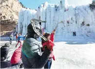  ?? PHOTOS BY WEI XIAOHAO / CHINA DAILY ?? Top: Hao Shuaifei, an avid climber, goes up a frozen waterfall during the competitio­n. Above: Beginners learn the basics of ice climbing.