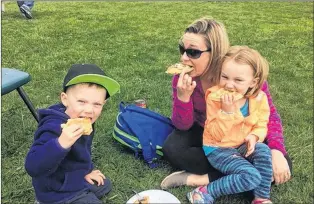 ?? TELEGRAM FILE/DEB SQUIRES ?? Leah Bartlett of St. Philip’s and her children Jace (left) and Brooke bite into some homemade waffles at the St. John’s Farmers Market in a 2017 file photo.