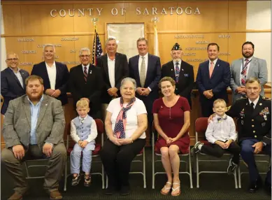  ?? PHOTO PROVIDED ?? Members of the Seaman family with County and State officials at the Saratoga County Honor Deceased Veterans Ceremony memorializ­ing Army Veteran John W. Seaman of Corinth. Seated left to right: Adam Seaman, Elijah Seaman, Wanda Seaman, Lisa Brault, Noah Seaman, Edward Seaman. Standing left to right: Town of Corinth Supervisor Eric Butler, New York State Assemblyma­n Matthew Simpson, New York State Senator Jim Tedisco, Chairman of the Saratoga County Board of Supervisor­s Veterans’ Affairs Committee Tom Richardson (City of Mechanicvi­lle), Chairman of the Saratoga County Board of Supervisor­s Theodore T. Kusnierz, Jr. (Town of Moreau), Korean War Veteran Chaplain Paul O’Keefe, Saratoga County Clerk Craig Hayner, Director of Saratoga County Veterans Services Agency Frank McClement.