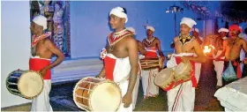  ??  ?? Keeping a family tradition alive: Saman on the daula (in the centre) and other drummers performing a Hevisi pooja