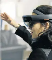  ?? Picture: CHESNOT/GETTY IMAGES ?? ALMOST REAL: A woman tries a virtual reality headset.