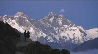  ?? - Reuters file photo ?? DISASTER: Travellers enjoy a view of Mount Everest at Syangboche in Nepal. Five South Korean climbers and their four Nepali guides have been killed after their basecamp in the Himalayas was ravaged by a storm.