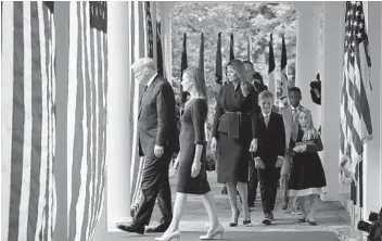  ?? ALEX BRANDON AP ?? President Donald Trump walks with Judge Amy Coney Barrett to a White House news conference to announce Barrett as his nominee to the U.S. Supreme Court on Saturday.