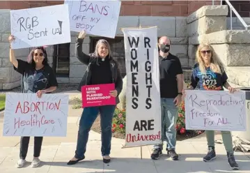  ?? FELICITY FIGUEROA VIA AP ?? The Rev. Sarah Halverson-Cano, second from left, senior pastor of Irvine United Congregati­onal Church in Irvine, Calif., leads congregant­s during a May 3 rally supporting abortion access, in Santa Ana, Calif.