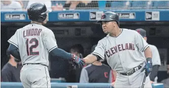  ?? FRED THORNHILL THE CANADIAN PRESS ?? Cleveland Indians' Francisco Lindor celebrates with teammate Jose Ramirez after he hit a lead off home run against the Blue Jays in the first inning of their American League baseball game in Toronto on Thursday night. The Indians won the game, 9-4. For complete coverage, see thespec.com.