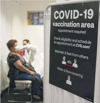  ?? MARCIO JOSE SANCHEZ/AP ?? A patient gets a COVID-19 vaccine at a CVS pharmacy in Los Angeles.
