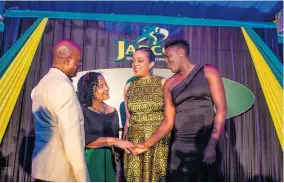  ??  ?? From left: Alexander Williams, chairman and June Spence-Jarrett, executive director, both of JADCO engage in dialogue with Leonie Phinn, team manager, Netball Jamaica and Vangelee Williams, vice captain, Netball Jamaica’s Sunshine Girls at JADCO’s Decennial Gala.