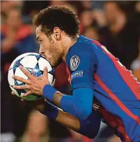  ?? AFP PIC ?? Barcelona’s Neymar kisses the ball after scoring during their Champions League match against Paris Saint-Germain on Wednesday.