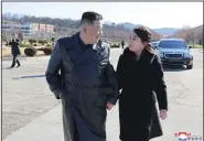  ?? (AP/Korea News Service/Korean Central News Agency) ?? North Korean leader Kim Jong Un (left) and his daughter (right) walk to a photo session at a recent claimed missile launch in North Korea.
