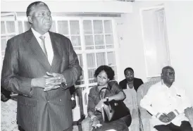  ??  ?? Acting President Phelekezel­a Mphoko and his wife Laurinda visited the late Cyril Ndebele family. In the picture he addresses mourners while his wife (centre) and Cde Tshinga Dube listen