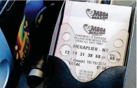  ?? [AP PHOTOS] ?? Mega Millions lottery tickets are printed out of a lottery machine at a convenienc­e store Wednesday in Chicago. The estimated jackpot for Friday’s drawing would be the second-largest lottery prize in U.S. history with a jackpot estimated to exceed $900 million.