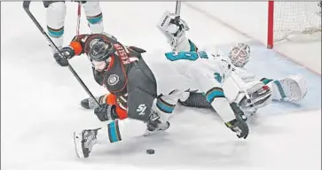  ?? Gina Ferazzi Los Angeles Times ?? THE DUCKS’ Ryan Kesler, left, is unable to reach a loose puck near the San Jose net. The Ducks looked sharper in Game 2 but several missed opportunit­ies resulted in another home loss.