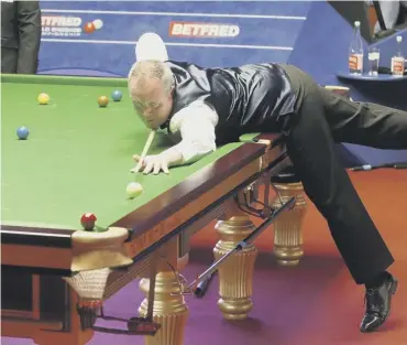  ??  ?? 0 John Higgins is poised to pot a red during his thrilling 13-12 quarter-final victory over Judd Trump.