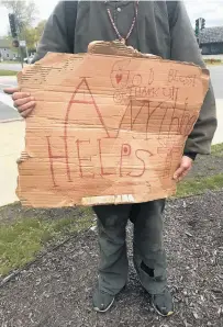  ?? DENISE CROSBY/BEACON-NEWS ?? Experts say more of the nation’s vulnerable population will resort to panhandlin­g, like this young man who was asking for donations of any kind because of the economic fallout from the never-ending coronaviru­s pandemic.